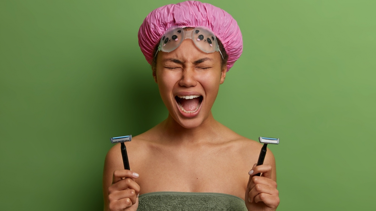 Frustrierte junge Frau mit Rasierutensilien