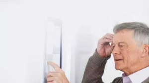 Confused_Senior_Man_With_Dementia_Looking_At_Wall_Calendar